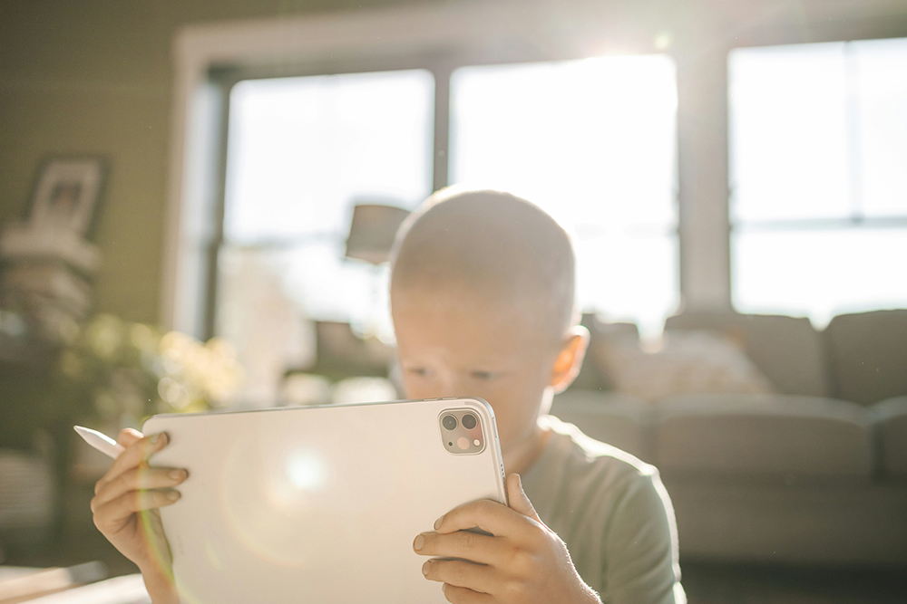 Photo of a child working on his iPad.